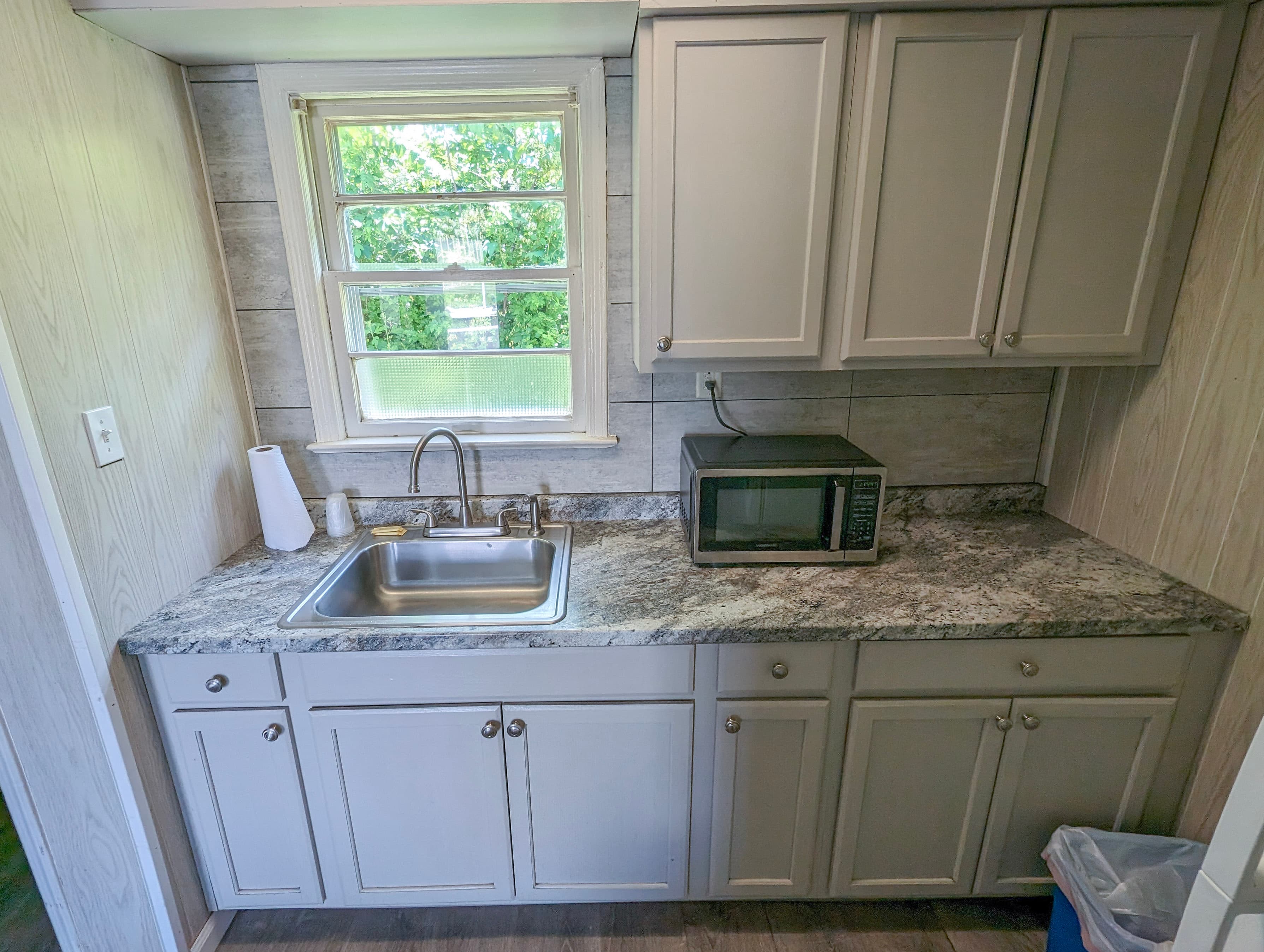 Kitchenette with granite countertops and microwave